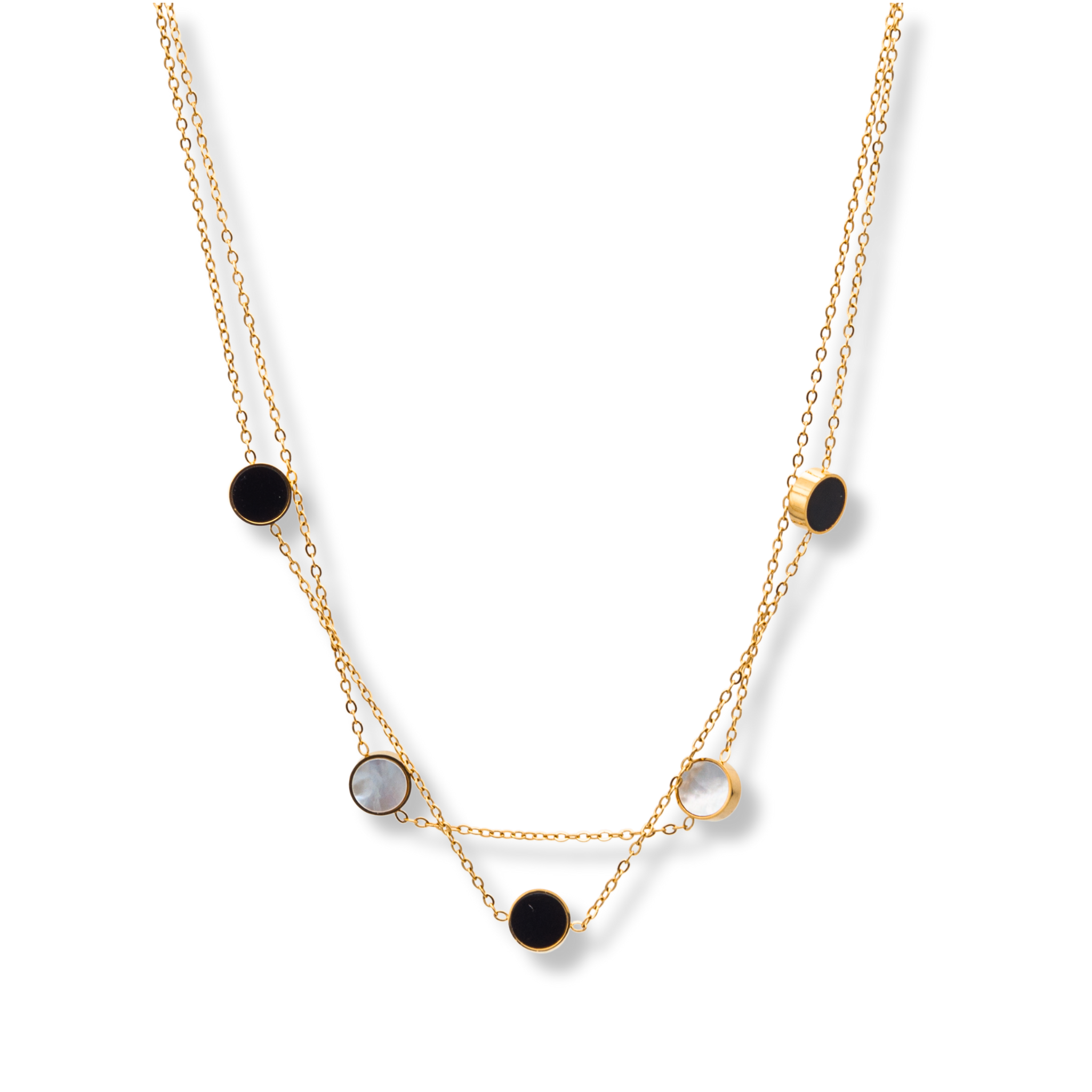 Halskette goldfarben mit runden Anhängern in Schwarz und Perlmutt, ideal für Layering.
Feine goldene Doppelkette mit schwarzen und weißen Details – zeitlos & modern.