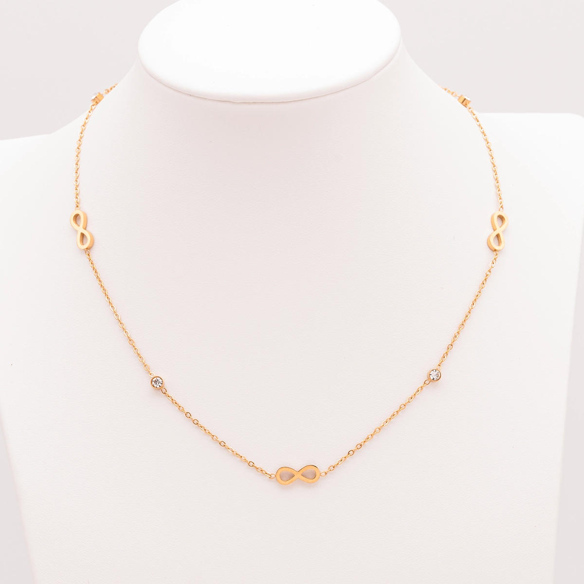 Elegante goldene Infinity-Kette mit Symbolanhängern und Strass-Details